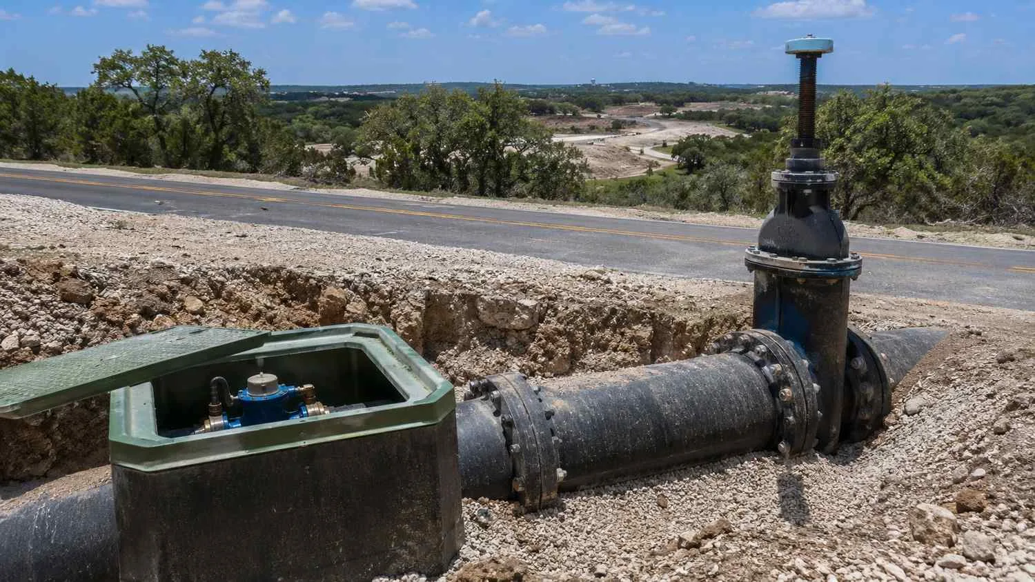 Water distribution main and valve assembly at Tarrant County development frontage.
