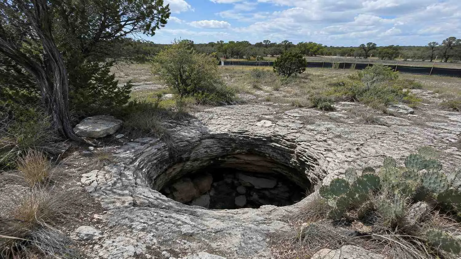 Karst sinkhole feature in Central Texas Hill Country terrain.