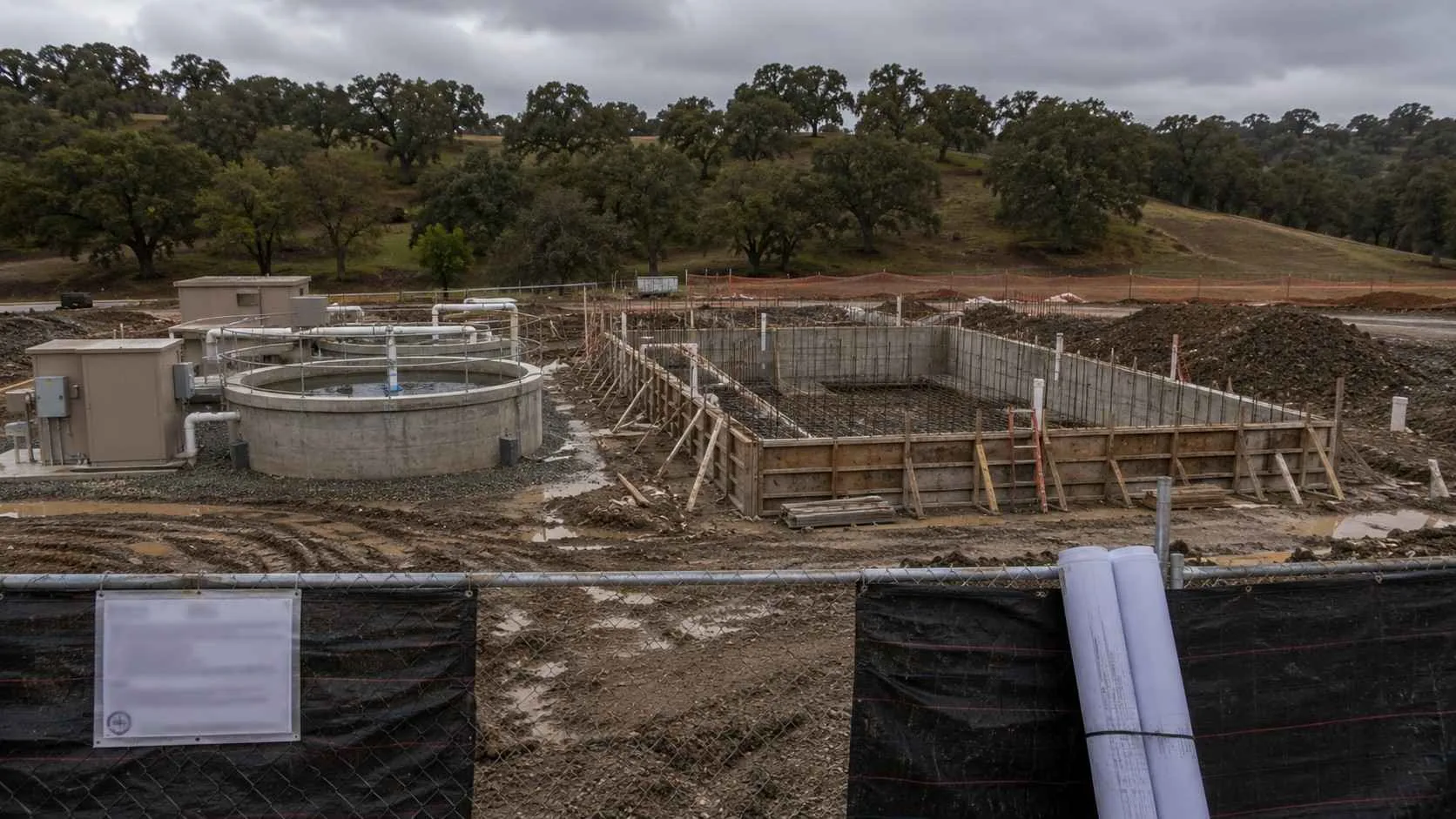 Partially constructed wastewater treatment system at California development site requiring redesign after permitting pathway change.