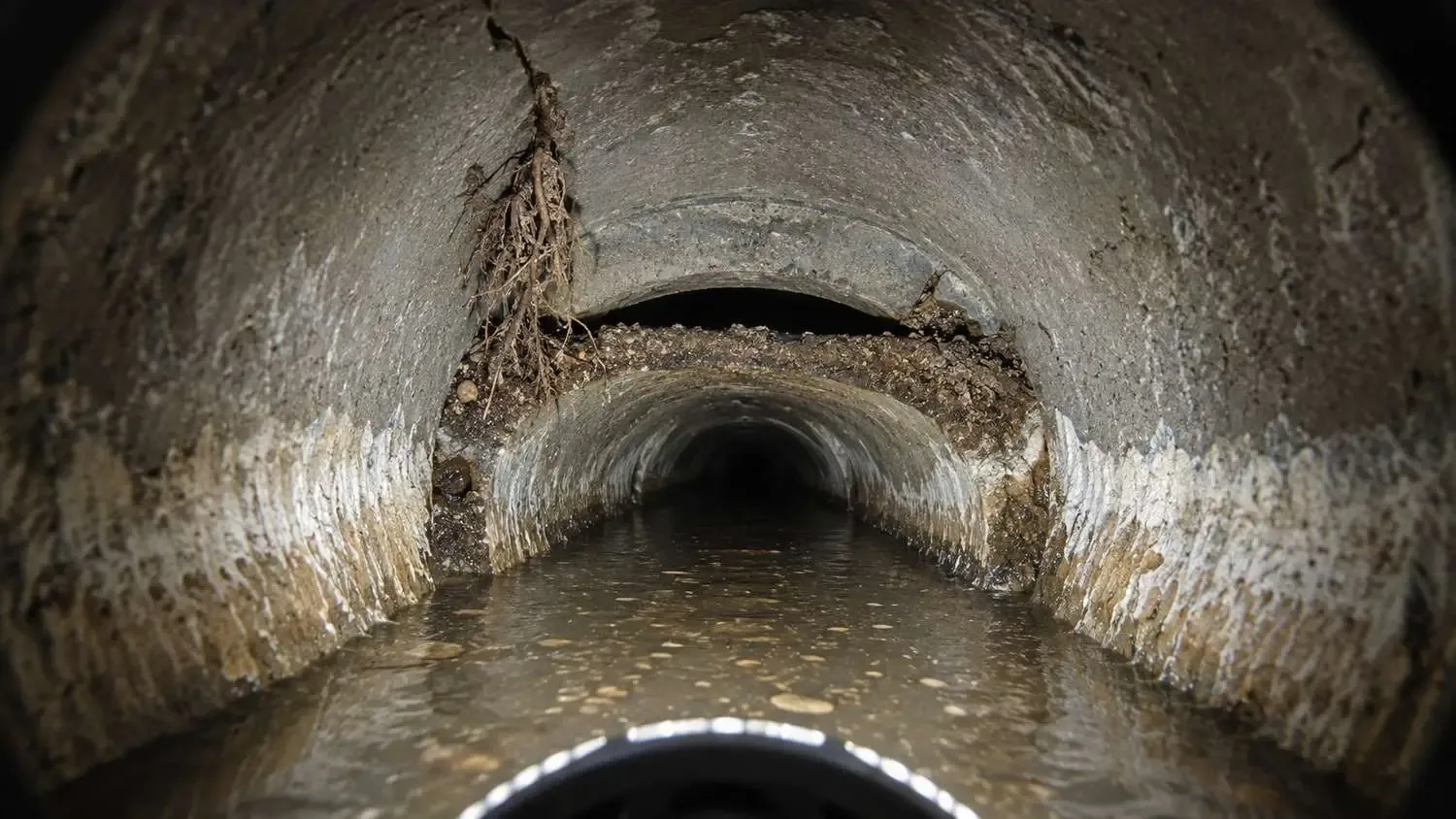 CCTV inspection of a deteriorated Florida coastal gravity sewer showing pipe joint failures and exfiltration defects.